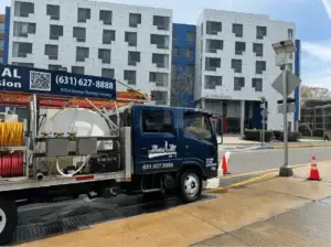 Technician performing trash chute cleaning at a Long Island healthcare facility